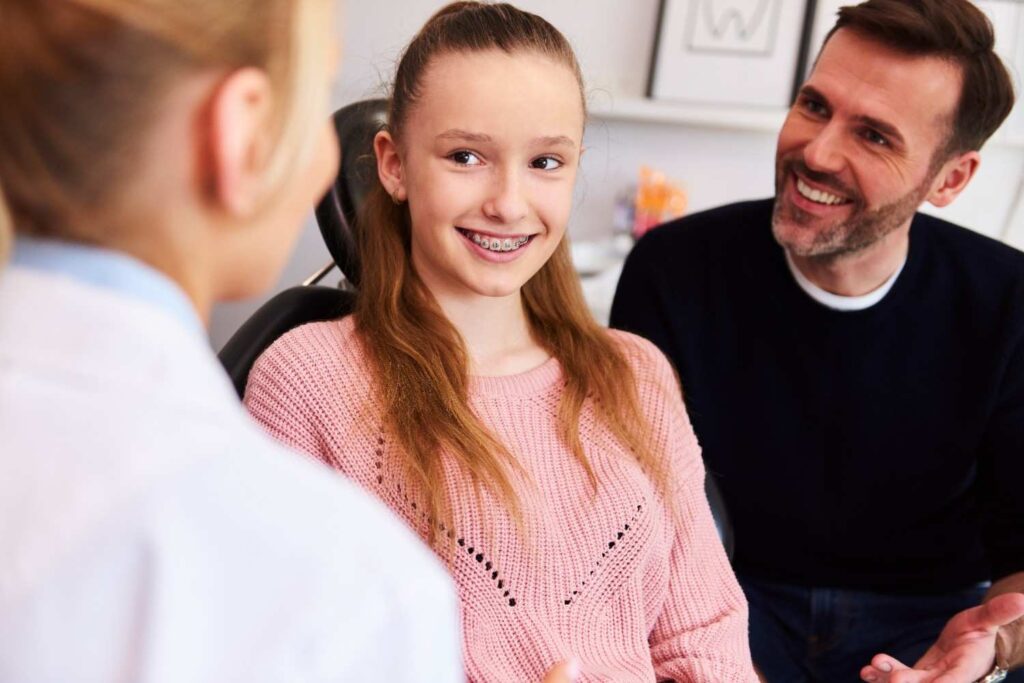 girl smiling looking at dentist